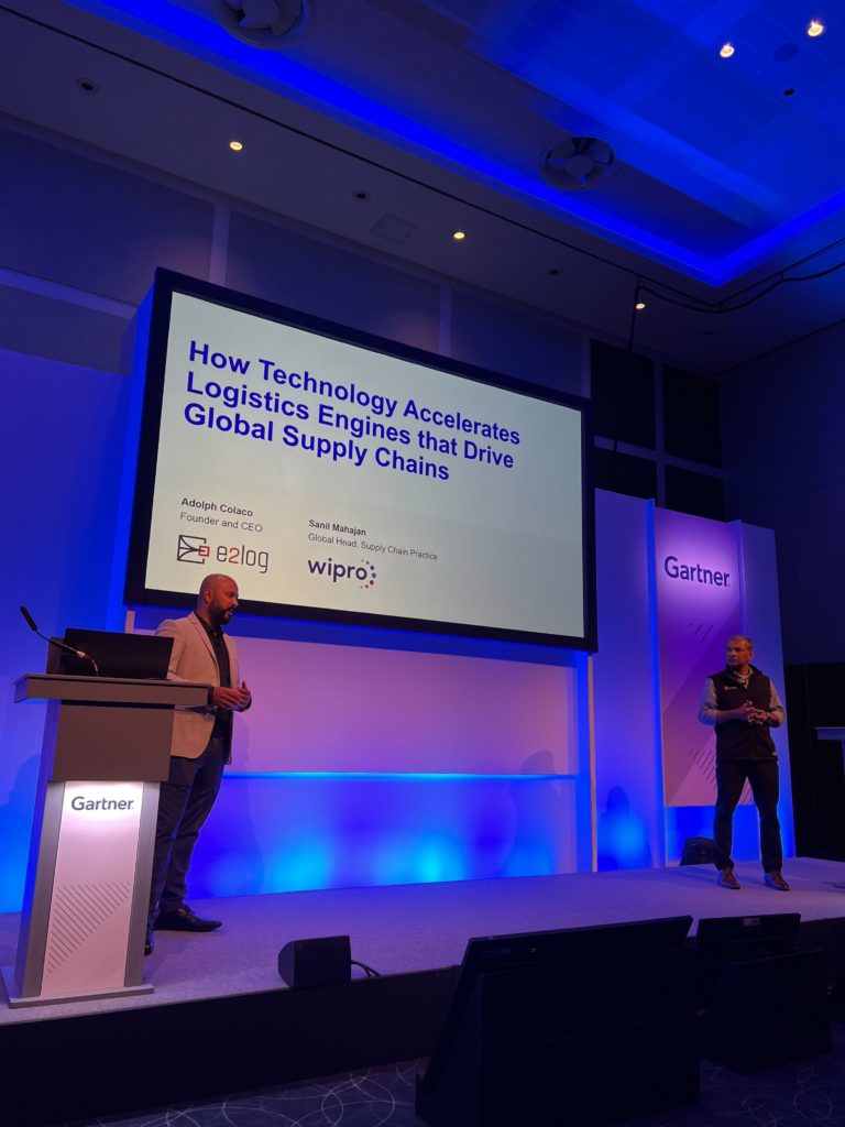 A presentation titled "How Technology Accelerates Logistics Engines that Drive Global Supply Chains" at a Gartner industry event.